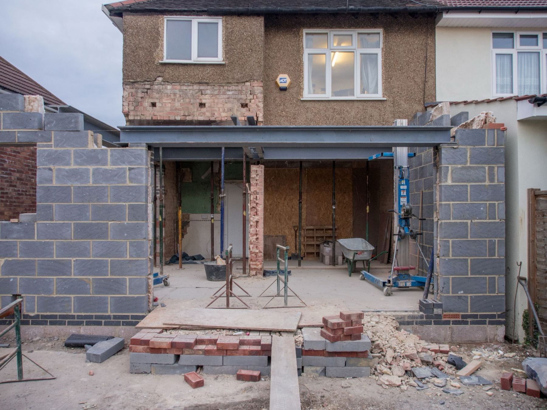 A rear extension under construction on a house — blockwork, steel and new openings