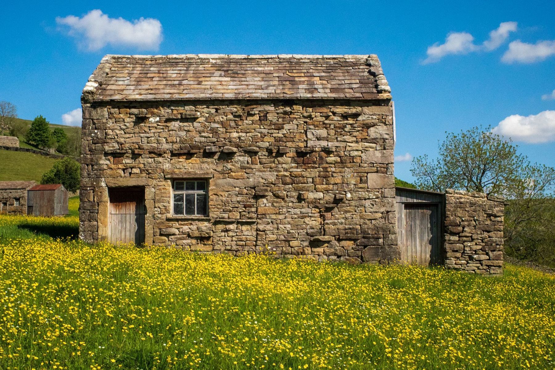 A traditional stone barn in a North Yorkshire field