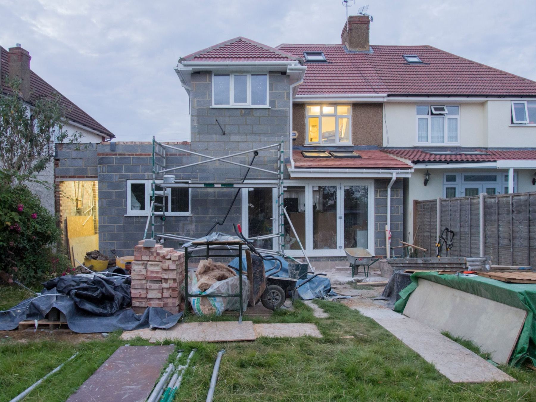 A house part-way through major renovation, scaffolded with building materials on site